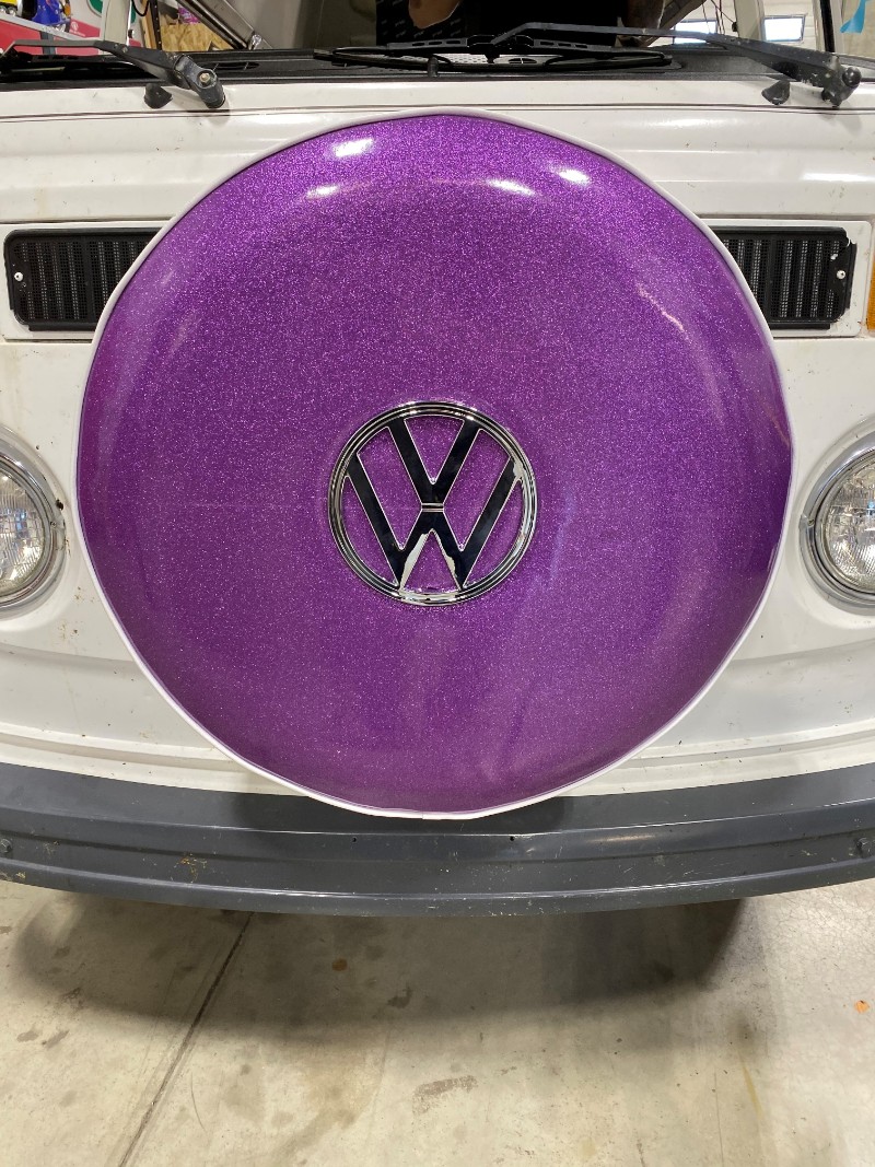car with purple tire cover